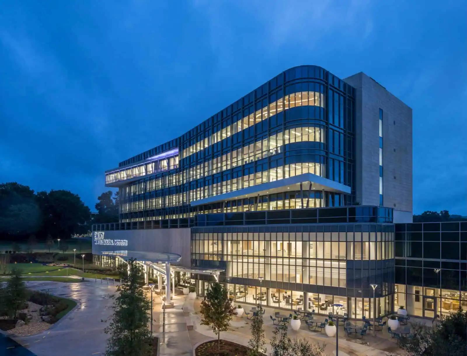 YKK corporate office building with modern glass architecture at dusk.