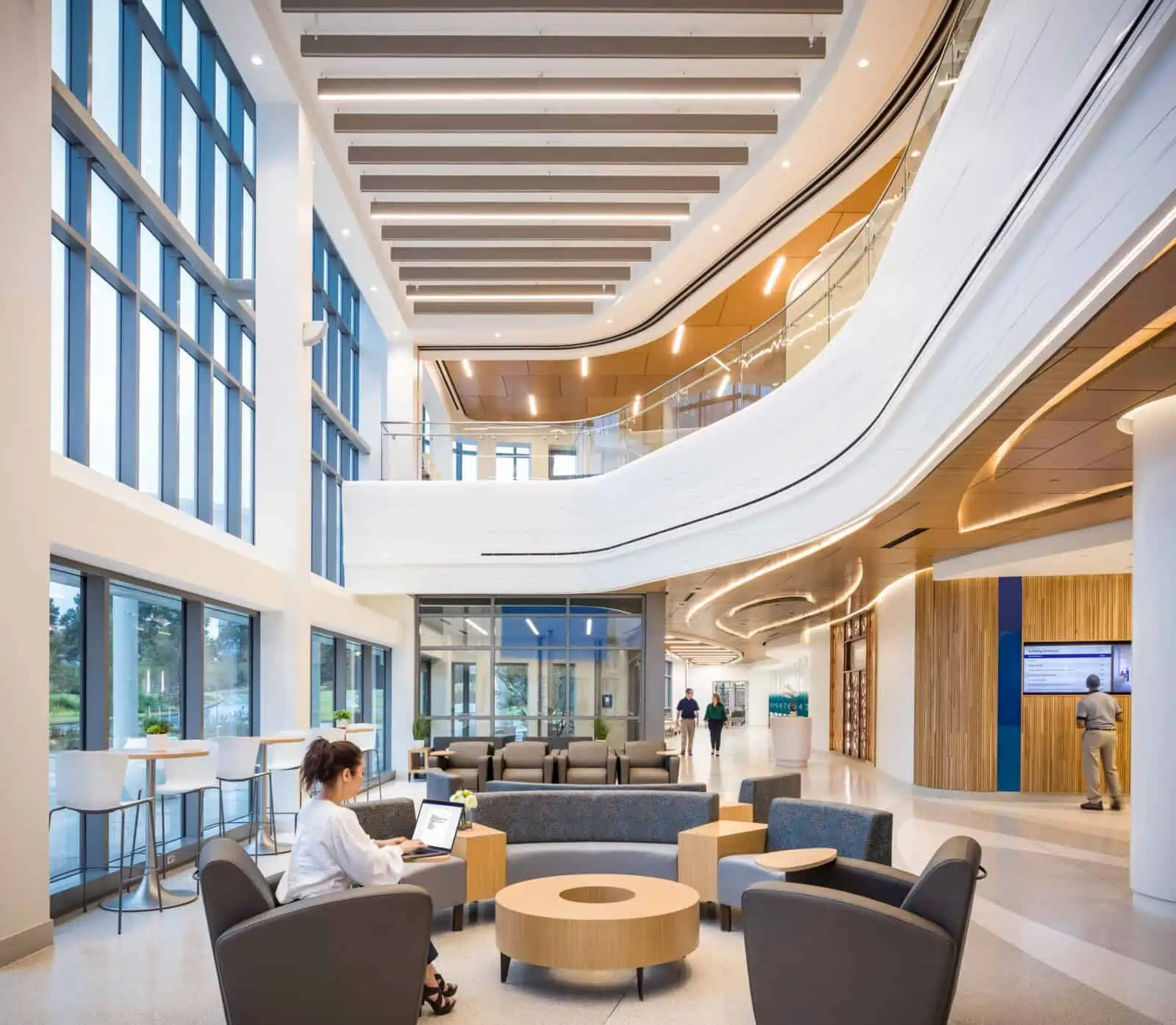 A modern, spacious office lobby with large windows and stylish seating areas.