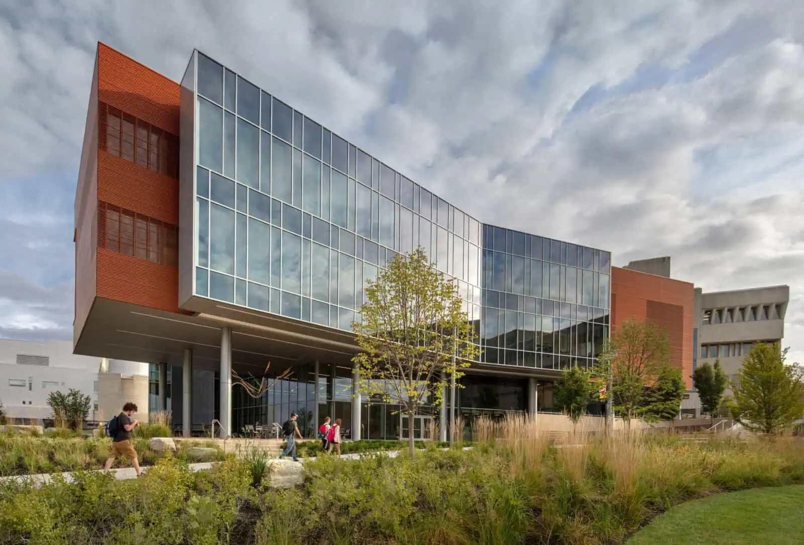 Modern office building with glass facade and landscaped surroundings.
