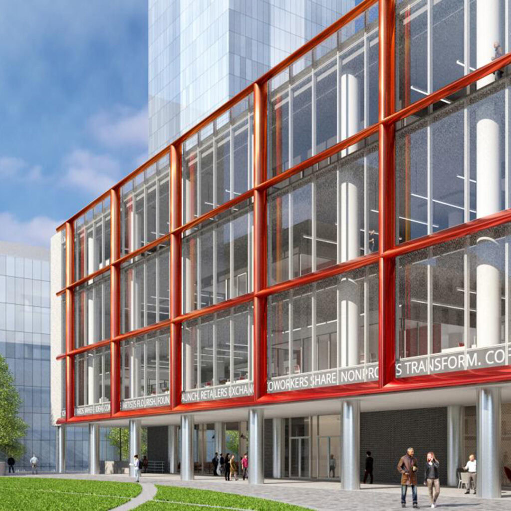 Office building with glass exterior and vibrant red framing elements.