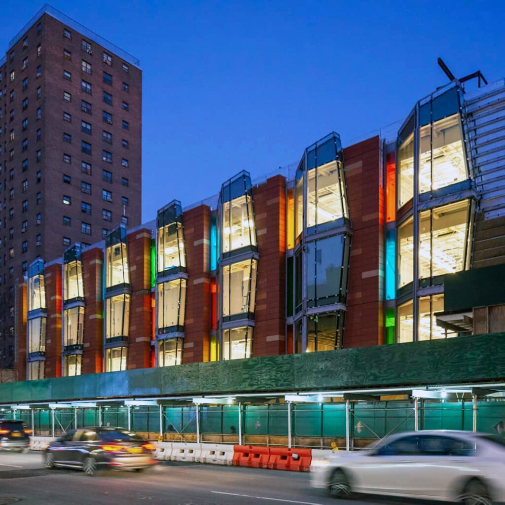 YKK modern building with colorful glass exterior and urban setting.
