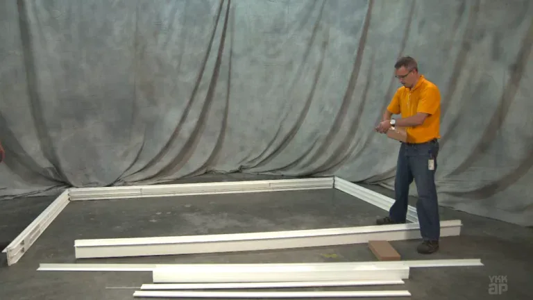 A person inspecting window frame components in a manufacturing or assembly setti.