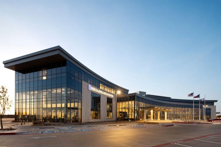 YKK manufacturing facility with modern glass architecture and clear signage.