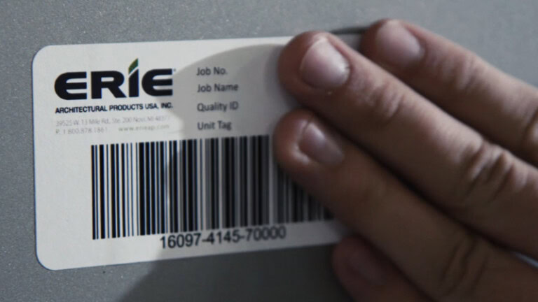 YKK architectural window label with barcode and specifications.