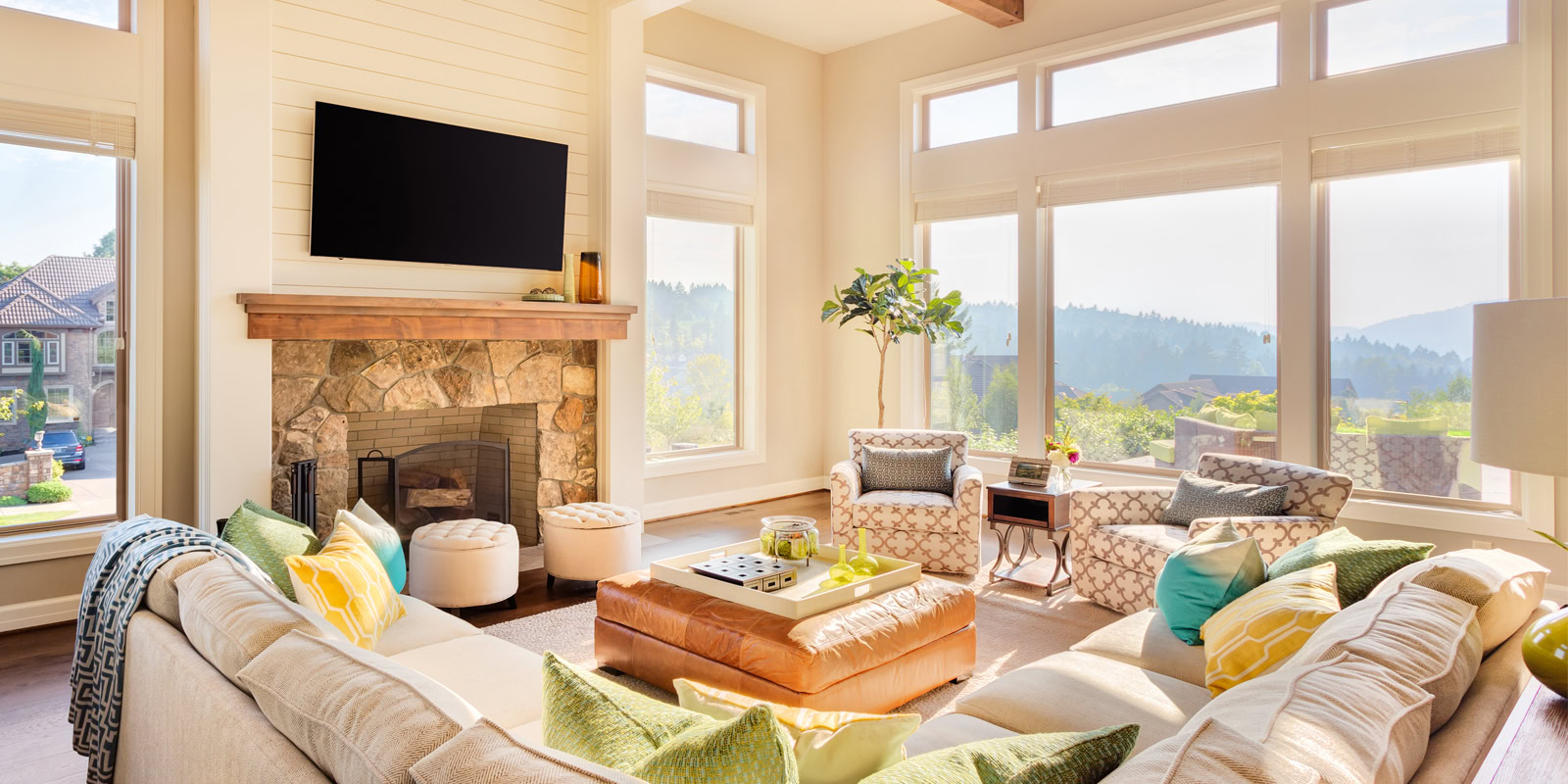 Bright living room with large windows and scenic outdoor view.