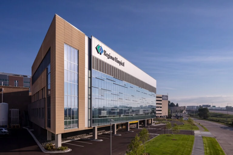 YKK corporate building with modern glass facade and landscaping.