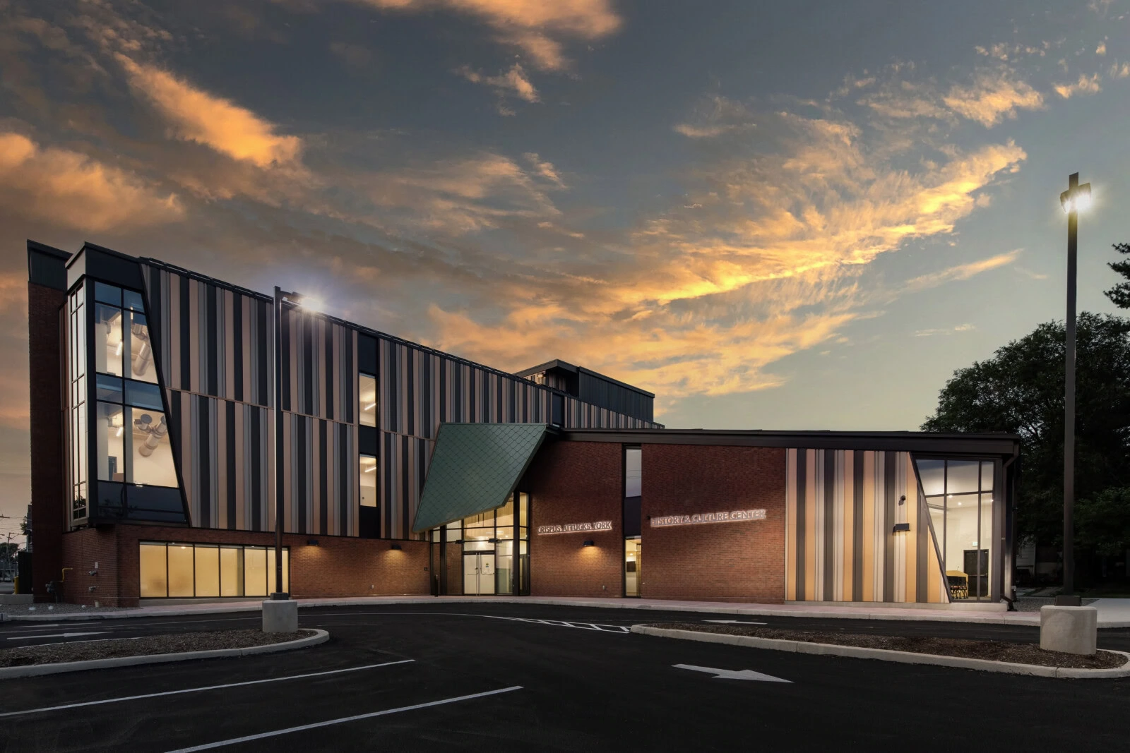 Modern YKK building with colorful exterior at sunset.