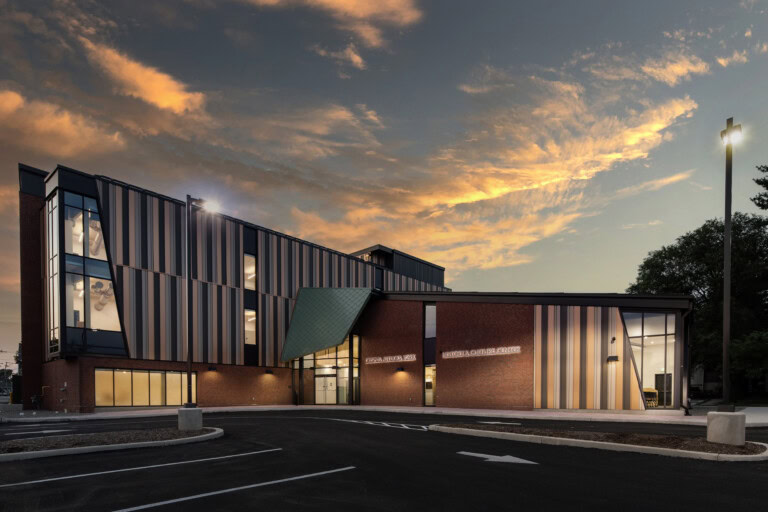 Modern YKK building with colorful exterior at sunset.