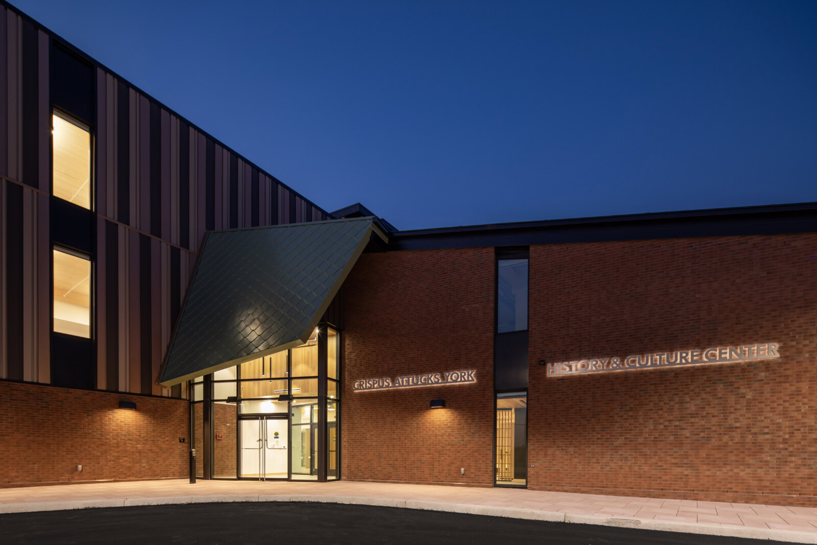 Modern Crispus Attucks History and Culture Center building at night.