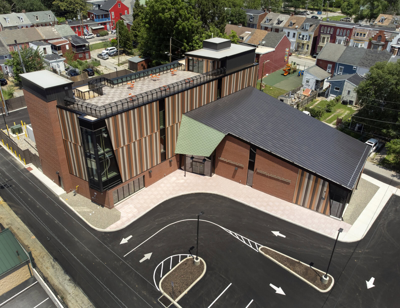 Contemporary building with colorful exterior and rooftop terrace.
